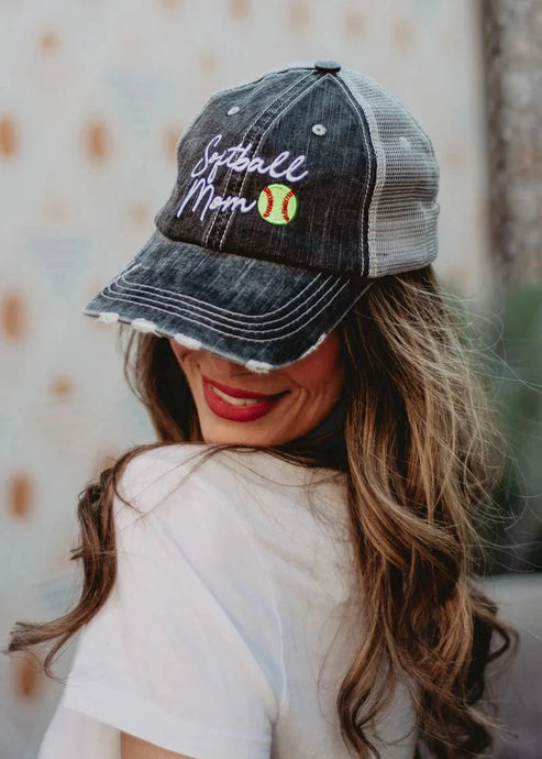 Woman wearing a denim cap with 'Softball Mom' text and a baseball graphic.